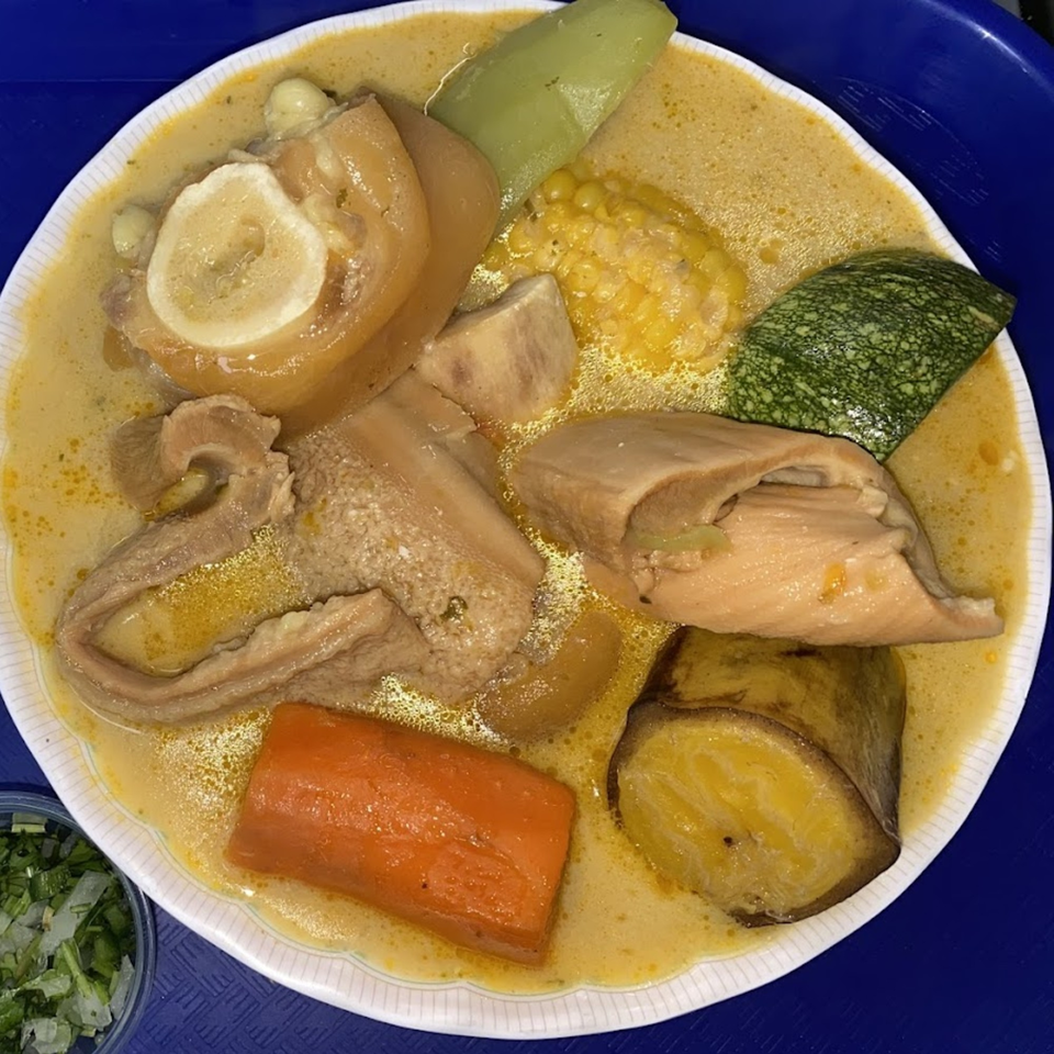 Honduran soup with meat, corn, plantains, carrots, and other vegetables in a creamy broth.